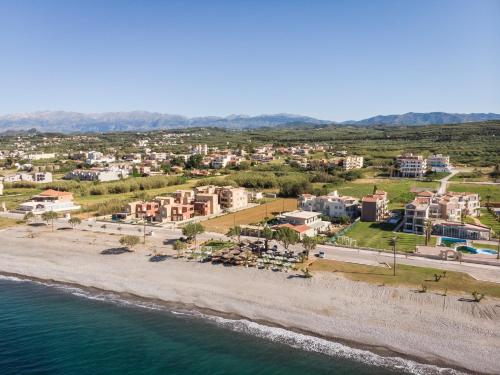 an aerial view of a resort on the beach at Aegean Breeze Luxury Apartments next to the sea in Maleme