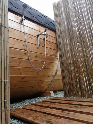 a wooden privacy fence with a shower in it at B&B Cascina Sant'Elena in Bubbio