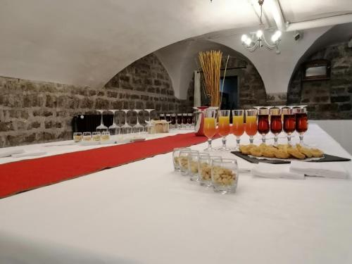 a white table with wine glasses and food on it at VTF Le Domaine Les Hautannes in Saint-Germain-au-Mont-dʼOr