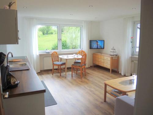 a kitchen and dining room with a table and chairs at Ferienwohnungen Irmengard in Bernau am Chiemsee