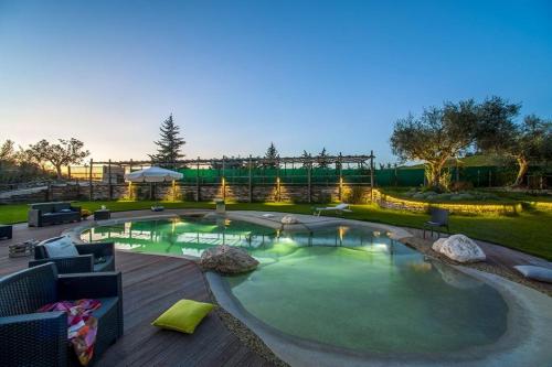 a large swimming pool with a deck and a playground at CasAnnona in Fermo
