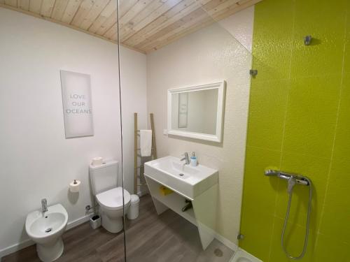 a bathroom with a sink and a toilet and a shower at Golden Halcyon - Ericeira Villas in Ericeira