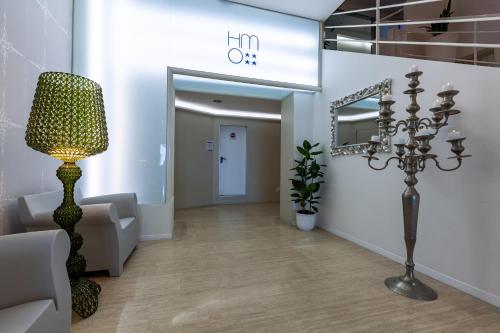 a living room with a lamp and a hallway at Hotel Mediterraneo in Riccione