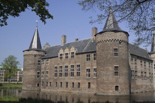 a large brick building with two towers on top at Golden Tulip West Ende in Helmond