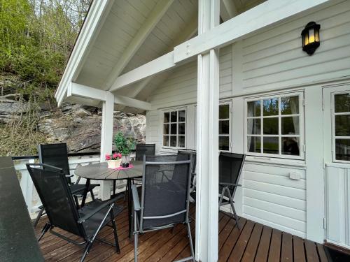 a patio with a table and chairs on a deck at Faleide Panorama in Stryn