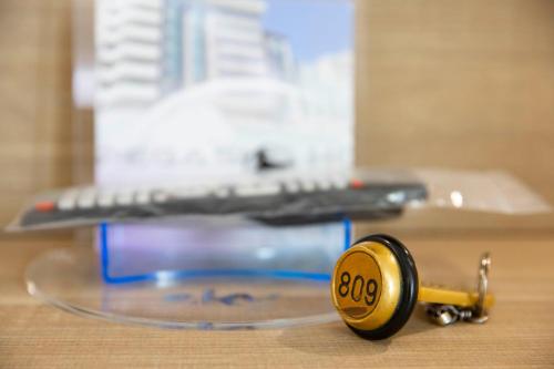 a key sitting on top of a table with a keyboard at Pegasus Hotel in Sassari
