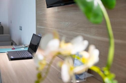 a laptop computer sitting on top of a table at Pegasus Hotel in Sassari