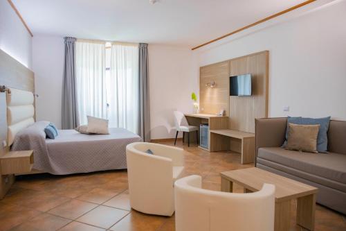 a hotel room with a bed and a couch at Pegasus Hotel in Sassari
