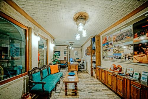 a living room with a couch and a table at Elysee Cave House in Goreme