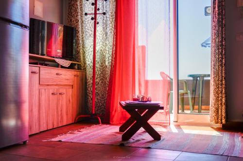 a room with a table in front of a window at Teixeira House in Arco da Calheta