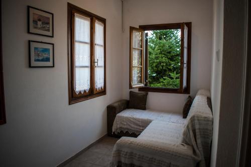 a room with two beds and two windows at Casa Levante in Keramídhion