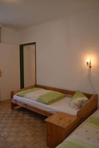 a bedroom with a wooden bed in a room at Haus Rohskopf in Mallnitz