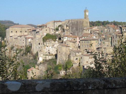 a town on a hill with a clock tower at Hotel La Torricella in Capalbio