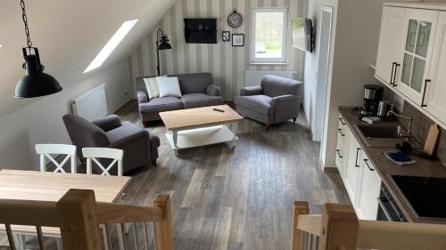 a living room with a couch and a table at Café Ilse - Ferienwohnungen in Ranis