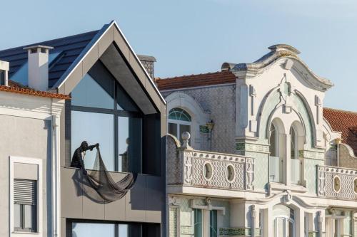 a hammock hanging from the window of a house at Cais do Pescador in Aveiro