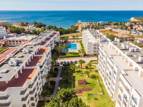 an aerial view of a building with the ocean in the background at Quinta das Palmeiras Pool & Beach in Pêra in Porches