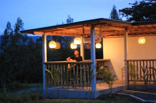 a man sitting at a bar in a gazebo at Tampurhyangview in Kintamani