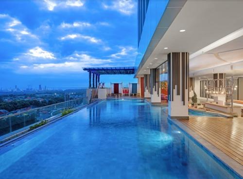 a pool on top of a building with a view at Aston Gresik Hotel & Conference Center in Gresik