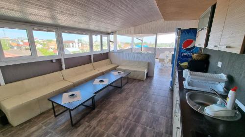 a living room with a couch and a sink at Casa Decebal in Eforie Nord