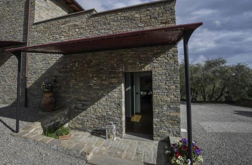a brick building with an awning over a door at B&B il Pianolo in Perinaldo
