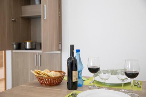 a bottle of wine and two wine glasses on a table at Pegasus Hotel in Sassari
