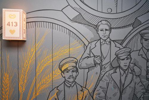 a mural of a group of men on a wall at McDreams Hotel München-Nord in Eching
