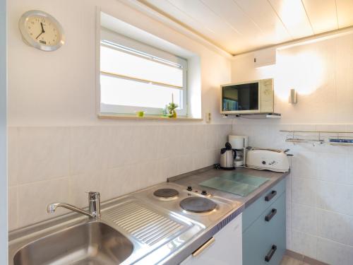 a small kitchen with a sink and a window at Ferienhaus Smerzinski in Bergen auf Rügen