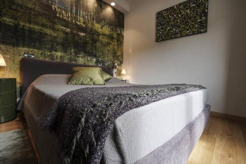 a bedroom with a bed with a blanket on it at B&B il Pianolo in Perinaldo