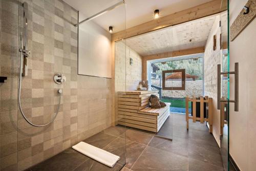 a bathroom with a shower and a glass door at App Mulin Rudl mit Sauna in Mühlbach
