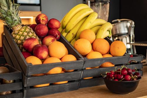 two wooden boxes filled with fruit on a table at My Suite Hotel in LʼAquila