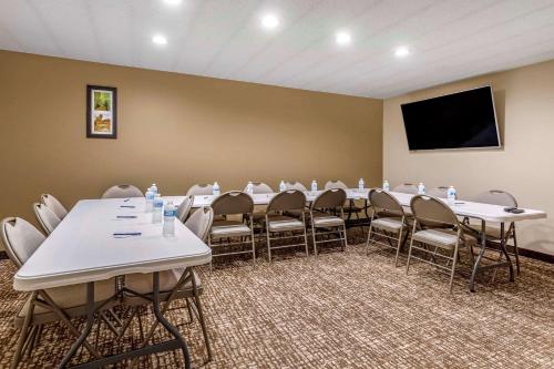 a conference room with tables and chairs and a flat screen tv at Comfort Inn Paducah I-24 in Paducah