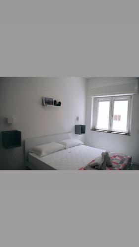 a bedroom with two beds and a window at B&B Le Palme in Diamante