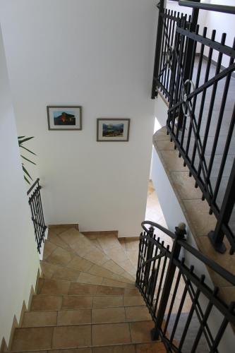 a stairway with two framed pictures on the wall and a white wall at Ferienhotel Samerhof in Pfarrwerfen