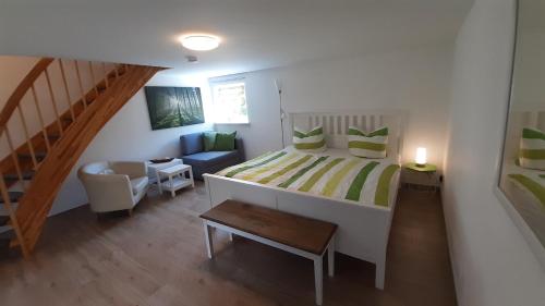 a small bedroom with a bed and a staircase at Christianshof Insel Usedom in Stoben