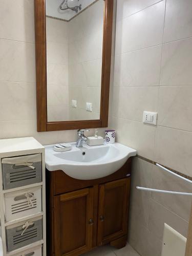 a bathroom with a sink and a mirror at B&B Vistamareblu in San Foca