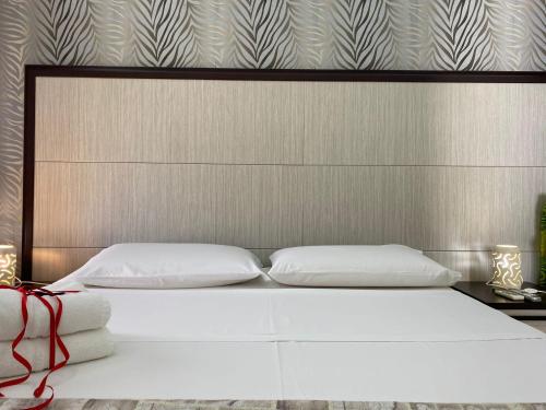 a bed with two white pillows in a bedroom at B&B Vistamareblu in San Foca
