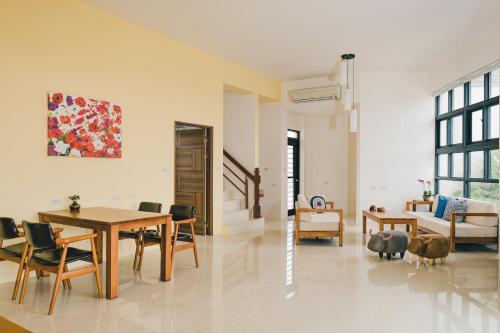 a living room with a table and chairs and a dining room at Destination Inn in Magong