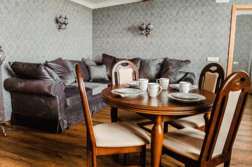 a living room with a table and a couch at Seaside Apartments Roja in Roja