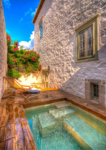a house with a swimming pool next to a building at Cotommatae Hydra 1810 in Hydra