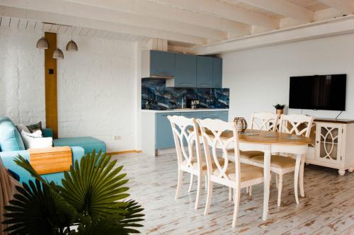 a kitchen and living room with a table and chairs at Seaside Apartments Roja in Roja