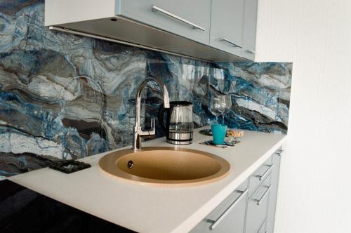a sink in a kitchen with a counter top at Seaside Apartments Roja in Roja
