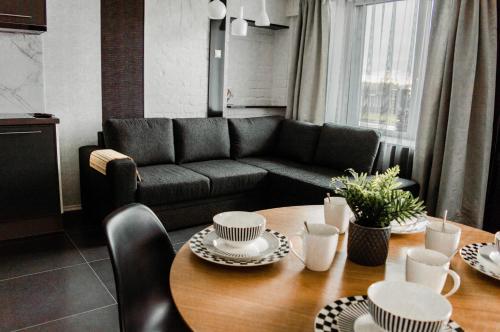 a living room with a couch and a table at Seaside Apartments Roja in Roja