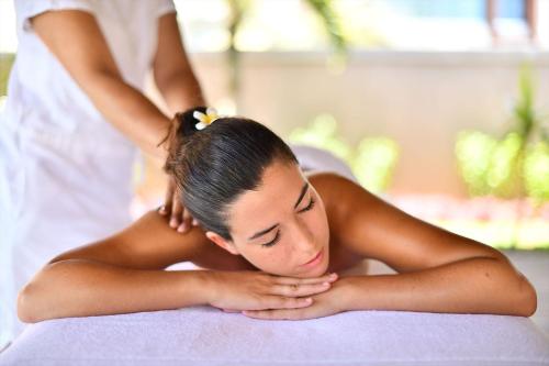 a woman laying on a bed getting a massage at Mythic Suites & Villas by MJ Holidays in Grand Gaube