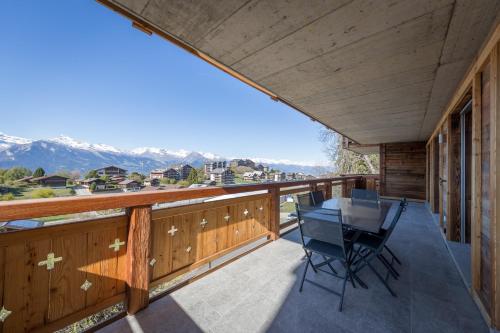 a balcony with a table and a chair on it at Apartment La Forêt 5 - Spa access - Centre Station in Nendaz