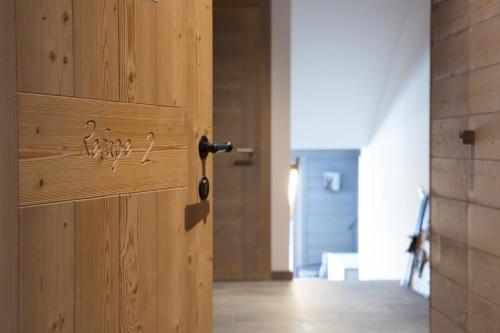 a wooden door with a handle in a room at Le Refuge 2 - Spa access - Close to ski lift in Nendaz
