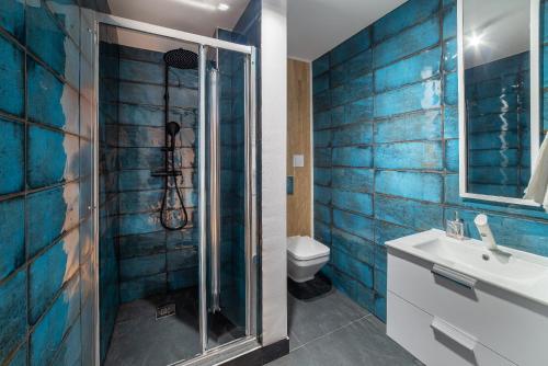 a bathroom with a shower and a sink and a toilet at Apartamenty PRZYSTAŃ - Chłopy, Blisko Plaży in Chłopy