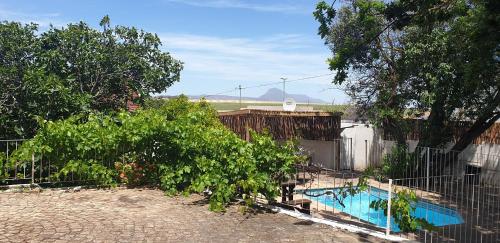 a fence with a swimming pool in a yard at Kelkiewyn Guesthouse Caledon in Caledon