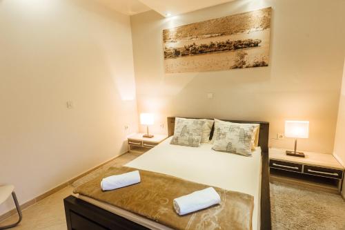 a bedroom with a bed and two night stands at Beachfront Apartments Tivat in Tivat