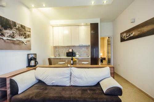 a living room with a couch and a kitchen at Beachfront Apartments Tivat in Tivat