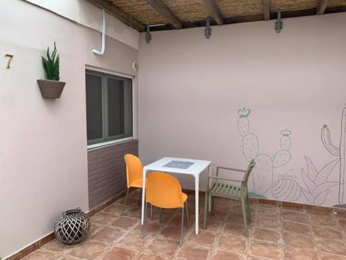 a patio with a table and chairs in a room at Marion Apartments in Kourouta